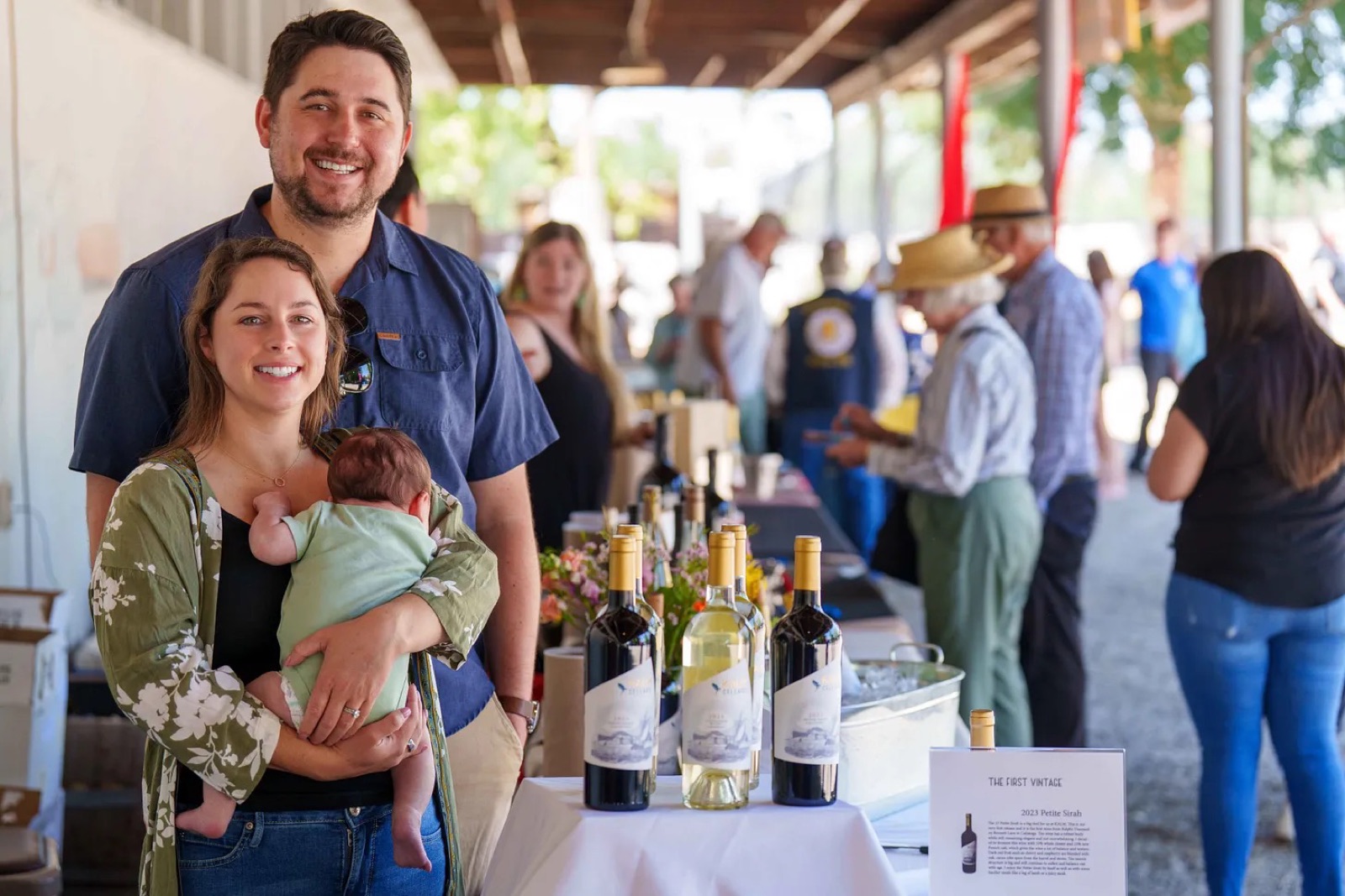 Kenny and Lindsey with their daughter, pouring KALM's first vintages at a tasting in Calistoga
